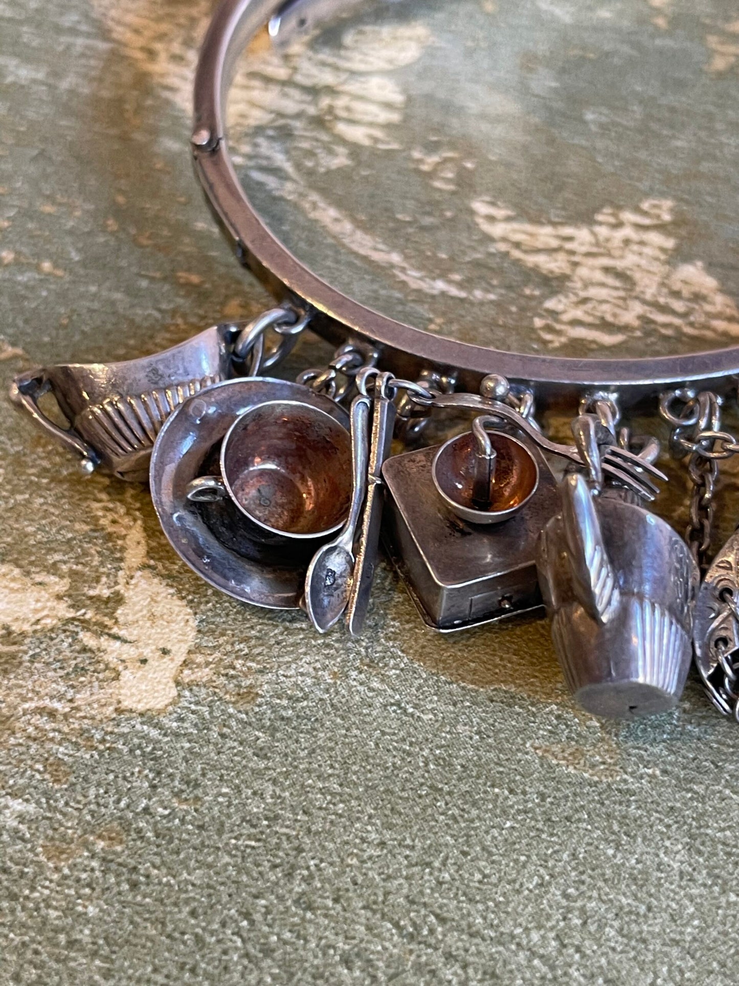 Silver bracelet with belt buckle and charms, Edwardian era