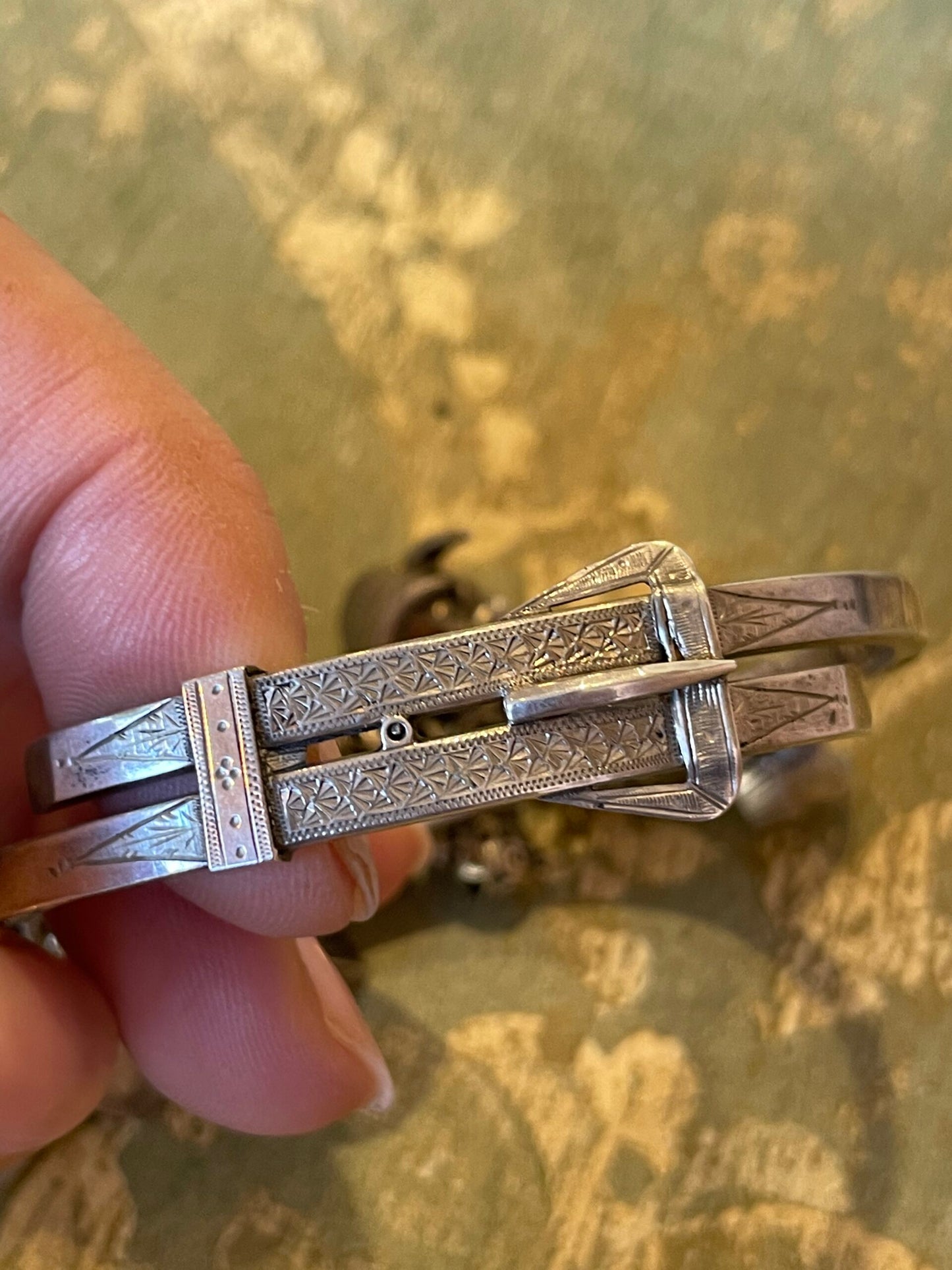 Silver bracelet with belt buckle and charms, Edwardian era