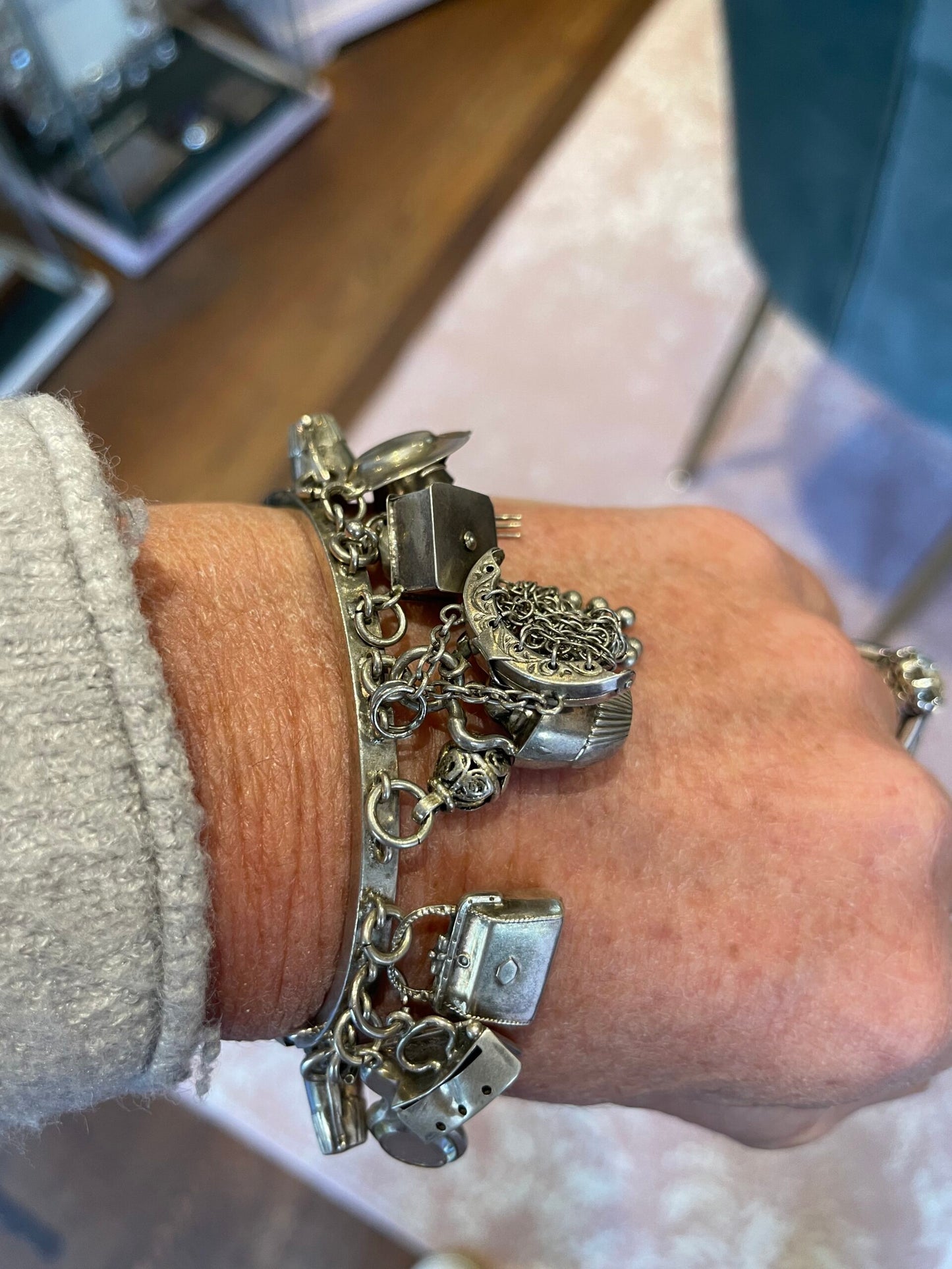 Silver bracelet with belt buckle and charms, Edwardian era