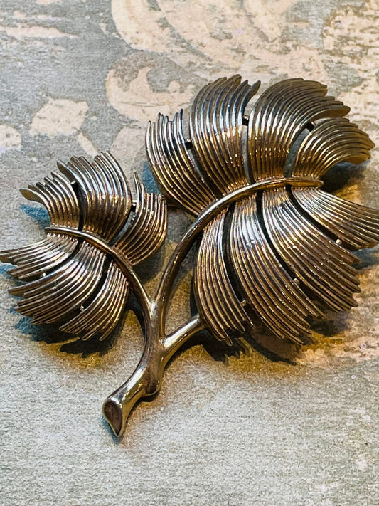 Golden brooch with branch of leaves, Trifari 1940